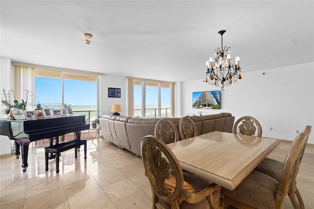 tiled dining room featuring a water view and an inviting chandelier