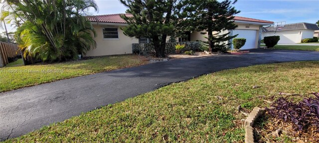 view of front of house featuring a garage and a front lawn