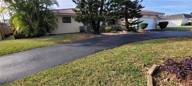 view of front facade with a garage and a front yard