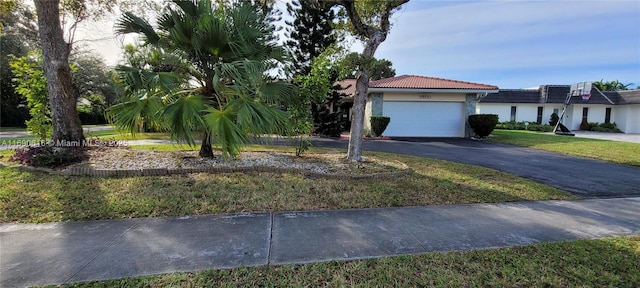 view of front of home featuring a garage and a front yard