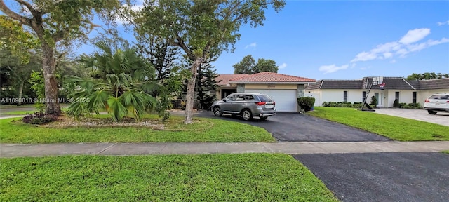 view of front of home featuring a garage and a front yard