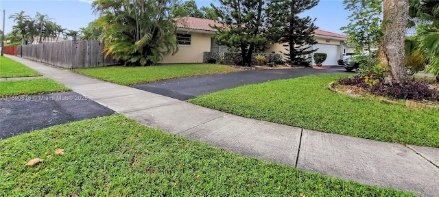 view of front of property featuring a garage and a front yard