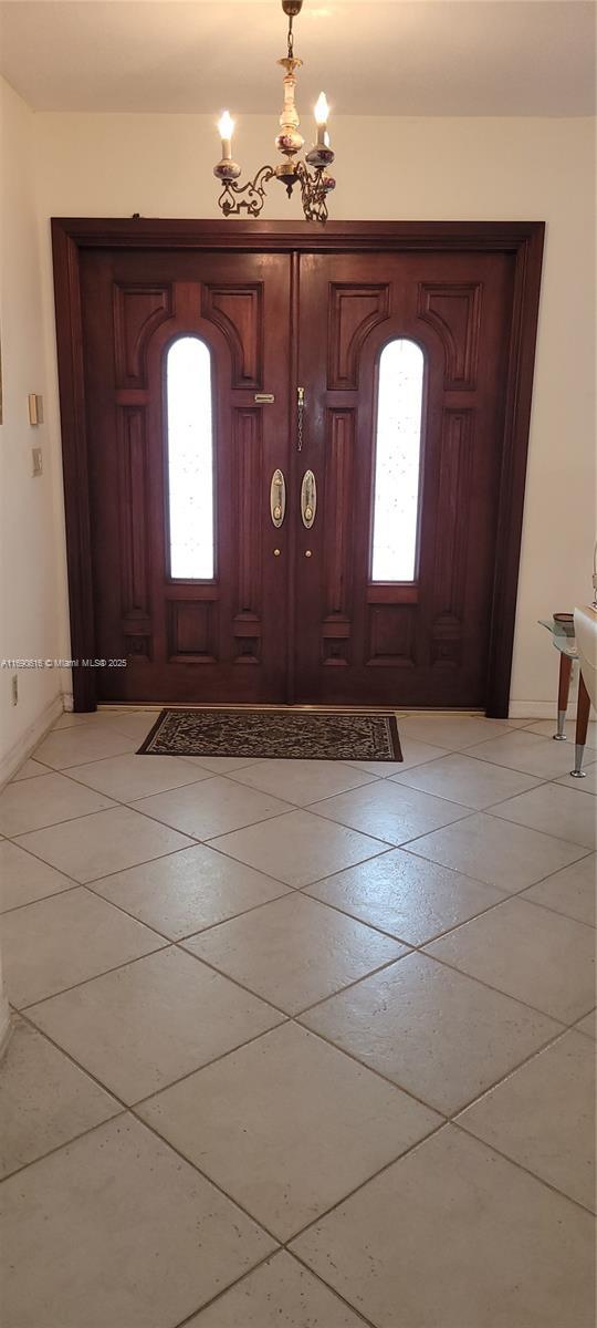 entrance foyer with an inviting chandelier and a healthy amount of sunlight