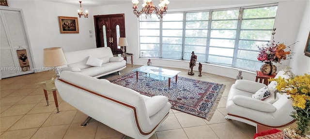 living room with light tile patterned floors and an inviting chandelier