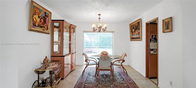 dining room featuring light tile patterned floors and an inviting chandelier