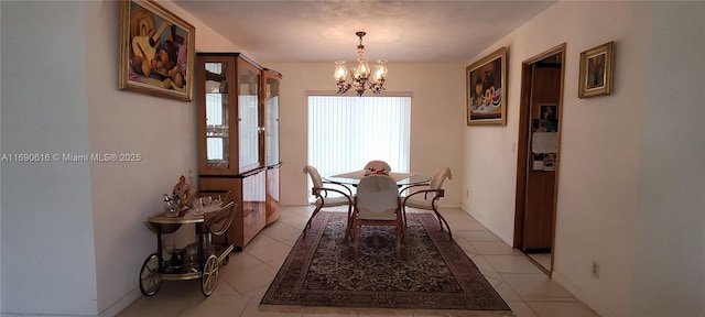 dining area featuring light tile patterned flooring and a chandelier