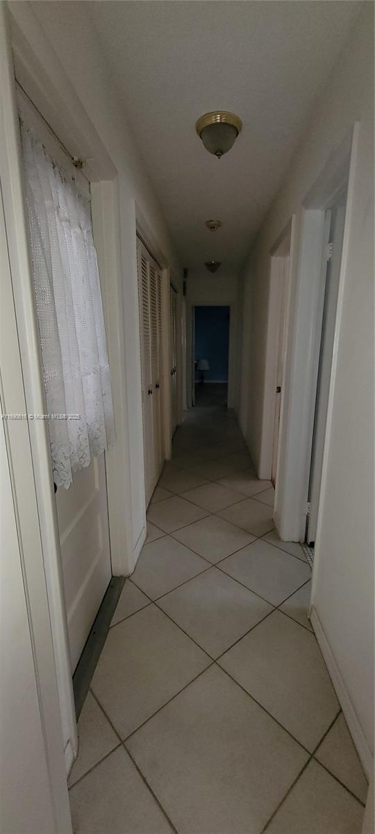 corridor with light tile patterned floors