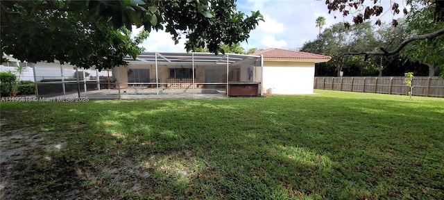 view of yard with a pool and glass enclosure