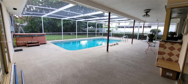 view of swimming pool with a hot tub, a patio, and glass enclosure