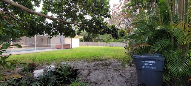 view of yard with a fenced in pool