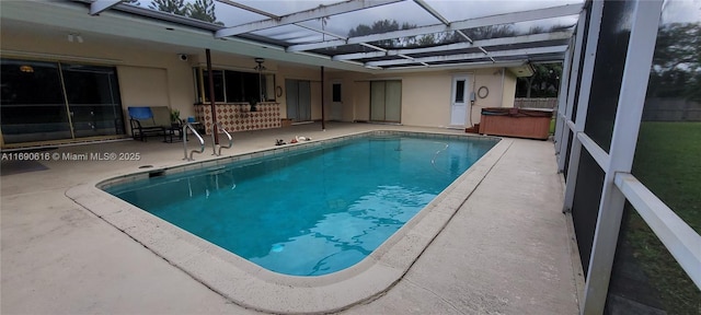 view of pool with a lanai, a hot tub, and a patio