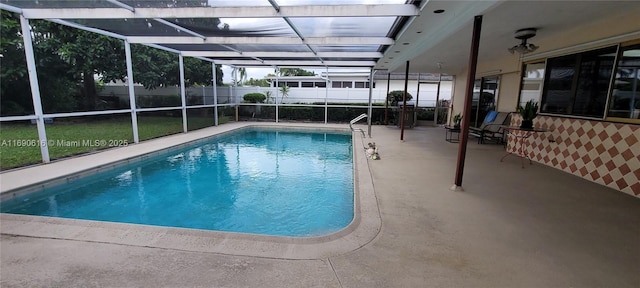 view of pool featuring a patio and glass enclosure