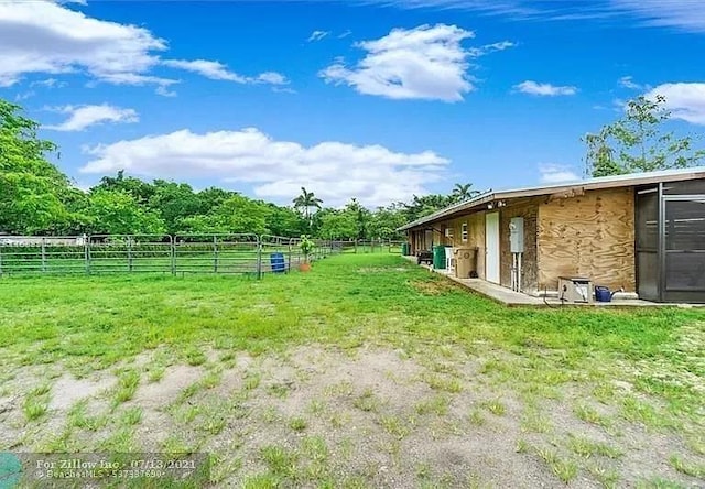 view of yard featuring an outbuilding and a rural view