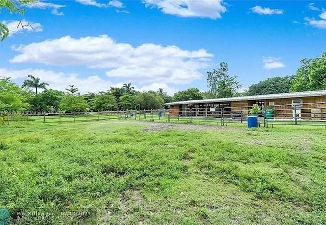 view of yard featuring an outbuilding and a rural view