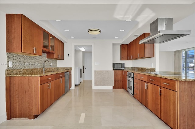 kitchen featuring black appliances, island exhaust hood, decorative backsplash, sink, and light stone counters