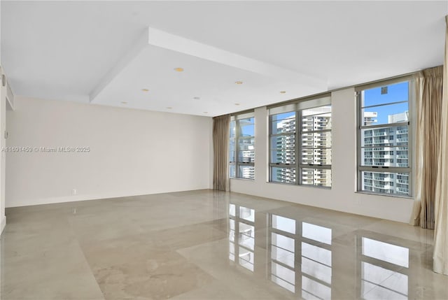 unfurnished room featuring expansive windows