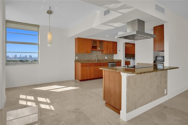 kitchen featuring decorative light fixtures, tasteful backsplash, dark stone countertops, black appliances, and island range hood