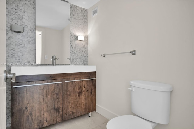 bathroom featuring toilet and vanity