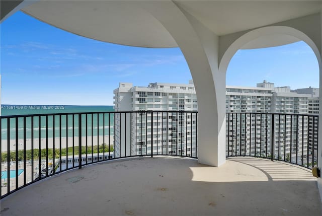 balcony with a view of the beach and a water view