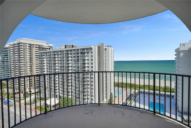 balcony with a beach view and a water view