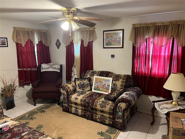 living room featuring ceiling fan and light tile patterned flooring