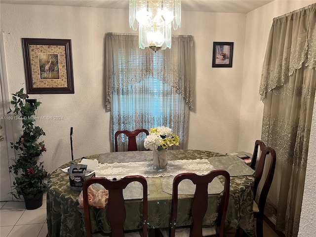 dining room featuring light tile patterned flooring and an inviting chandelier