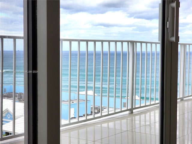 balcony featuring a water view and a beach view