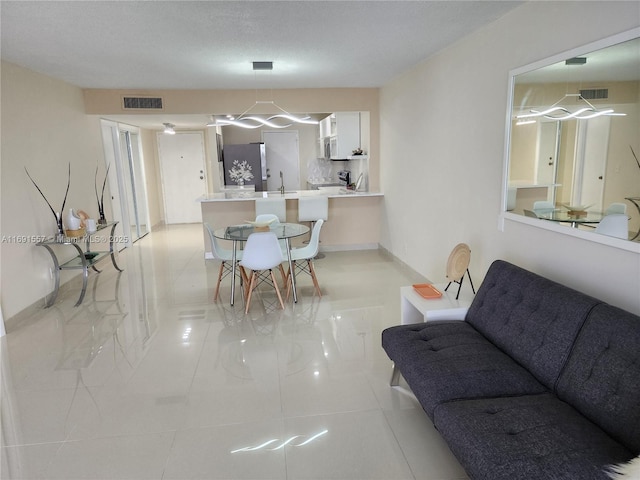 800 SE 20th Ave Unit 1109, Deerfield Beach, FL 33441 - living room with baseboards, light tile patterned flooring, and visible vents