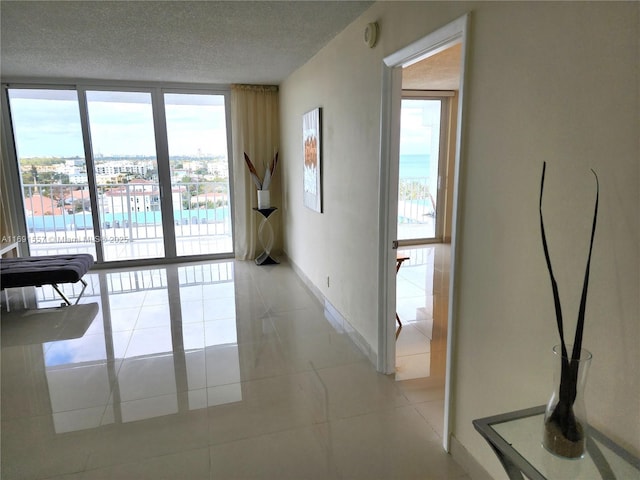 800 SE 20th Ave Unit 1109, Deerfield Beach, FL 33441 - empty room featuring baseboards, a textured ceiling, light tile patterned floors, and a wealth of natural light