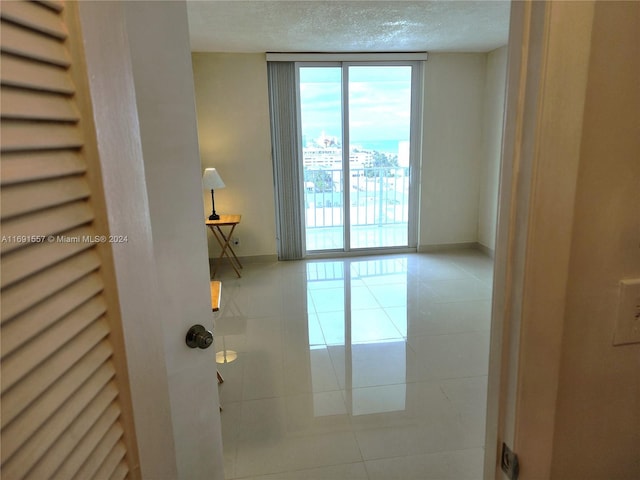 tiled empty room with a textured ceiling