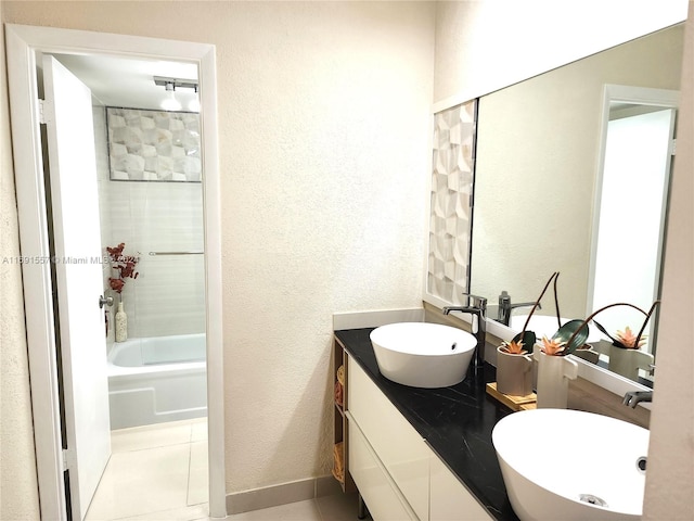 bathroom with vanity, tile patterned flooring, and tiled shower / bath combo