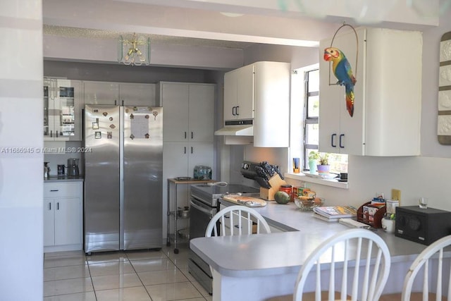 kitchen featuring light tile patterned flooring, white cabinetry, kitchen peninsula, electric range oven, and stainless steel fridge