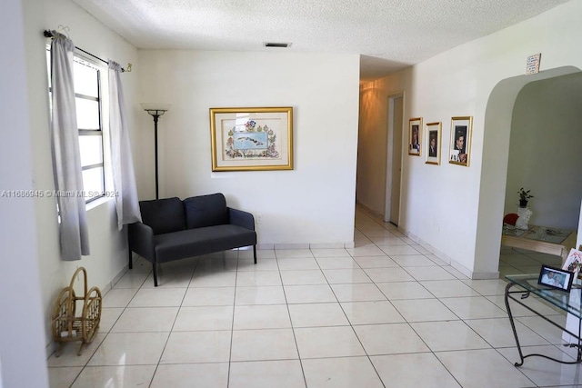 sitting room with light tile patterned flooring and a textured ceiling