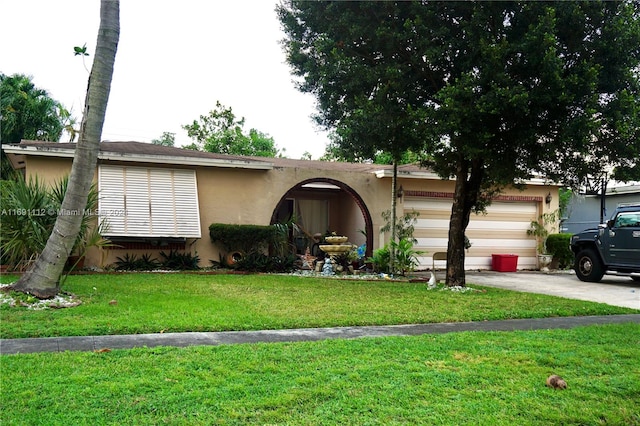 ranch-style home with a garage and a front yard