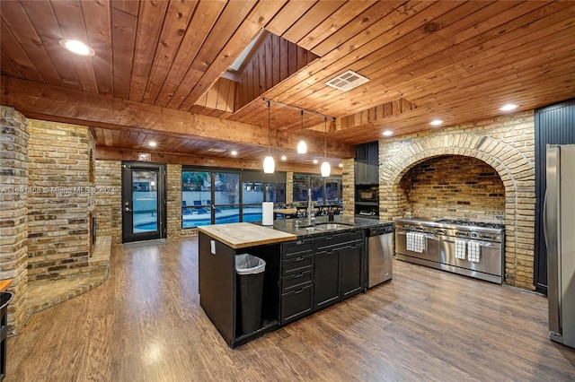 kitchen with wooden ceiling, hanging light fixtures, dark hardwood / wood-style floors, an island with sink, and appliances with stainless steel finishes