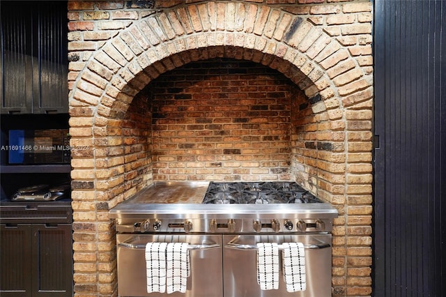 kitchen featuring brick wall and high end stainless steel range oven