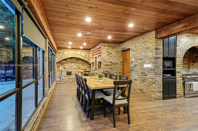 dining space with hardwood / wood-style floors and wooden ceiling