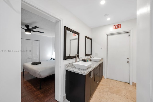 bathroom featuring vanity, hardwood / wood-style flooring, and ceiling fan