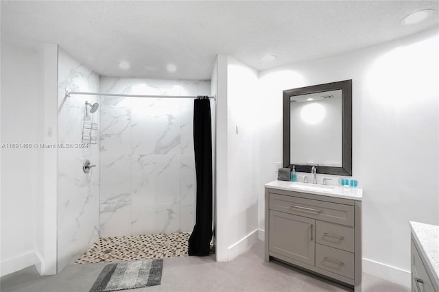 bathroom with a shower with shower curtain, a textured ceiling, and vanity