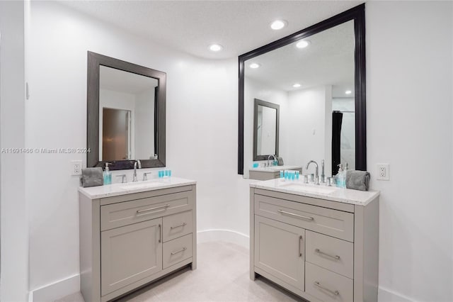 bathroom with vanity and a textured ceiling