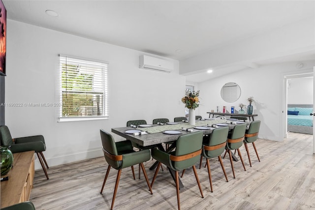 dining space with a wall unit AC, light wood-type flooring, and vaulted ceiling