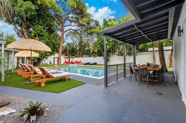 view of swimming pool with a shed, a yard, and a patio