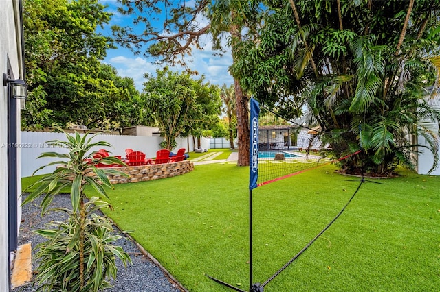 view of home's community with a lawn and a pool