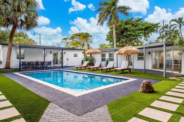 view of pool with a yard and a patio