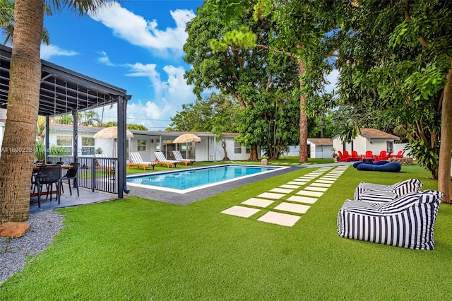 view of pool featuring a lawn and a patio