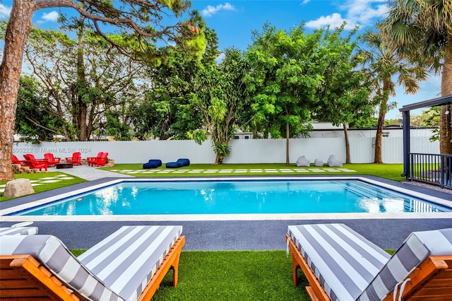 view of swimming pool with a lawn and a patio