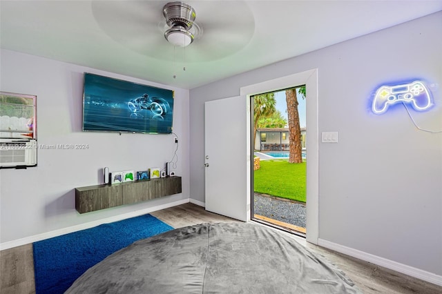 interior space with wood-type flooring and ceiling fan