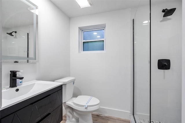 bathroom featuring an enclosed shower, vanity, hardwood / wood-style flooring, and toilet