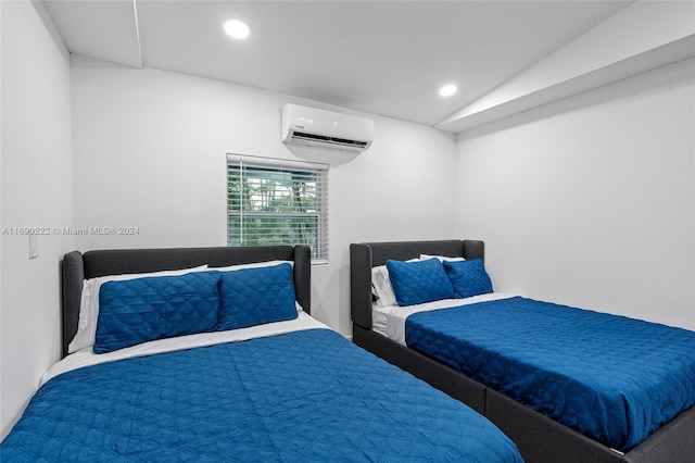 bedroom featuring an AC wall unit and vaulted ceiling