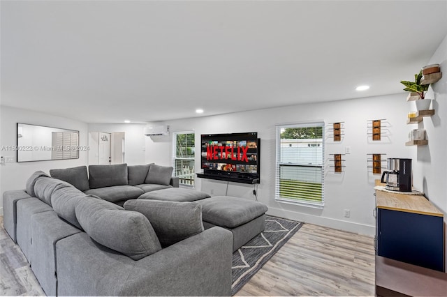 living room featuring hardwood / wood-style floors and a wall mounted air conditioner